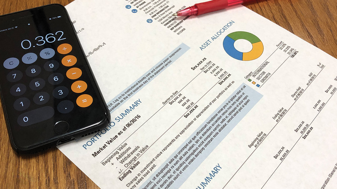 Mobile phone calculator and finance document Mobile phone calculator and finance document